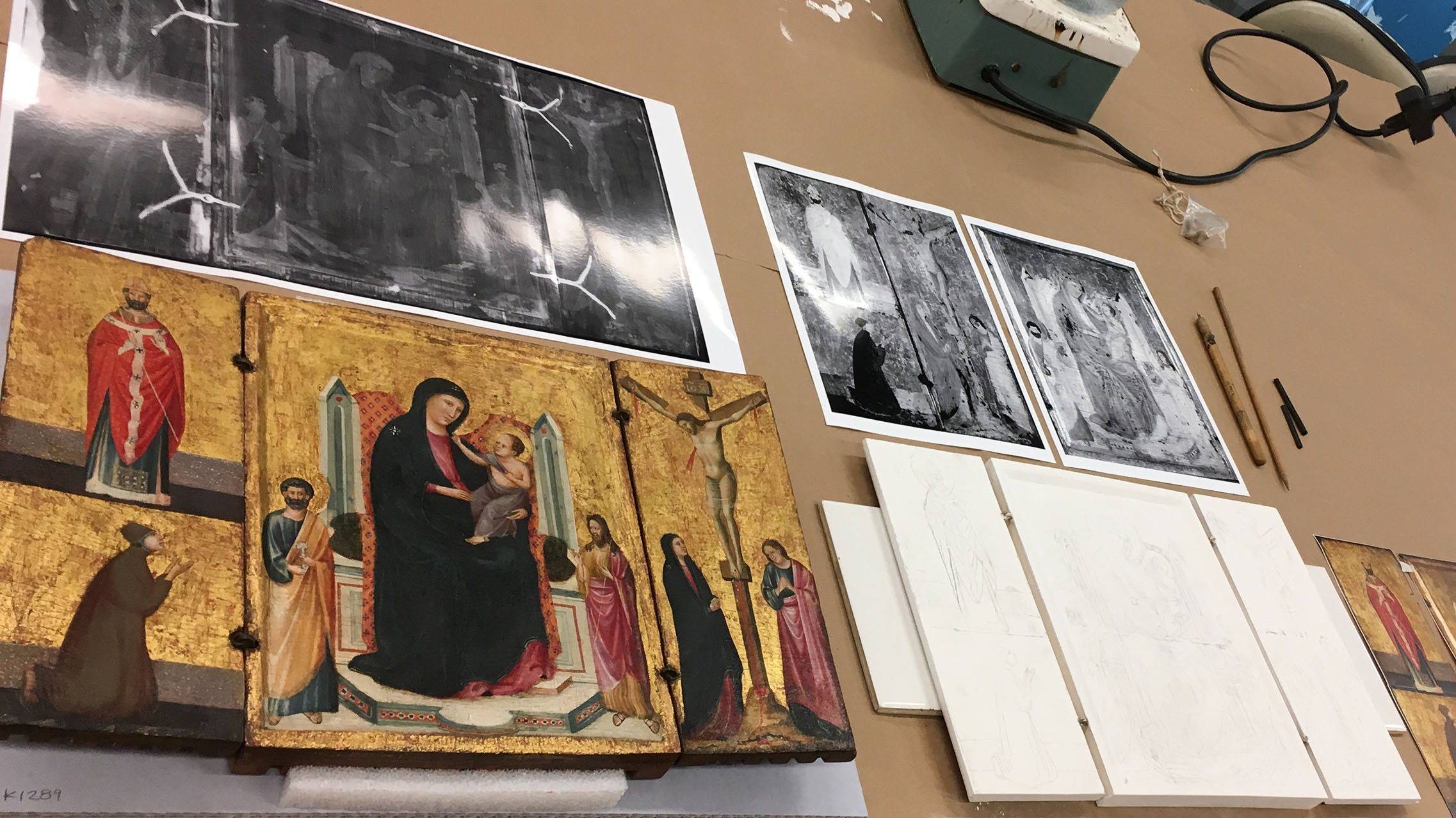 View of the artwork and in-progress reconstruction, along with printouts of technical imaging