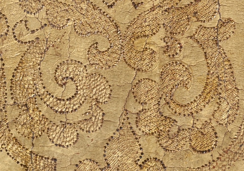 Figure 4: Detail of brocade showing freeform character of incised lines, loose correspondence between punchwork and lines, and partially finished stippling of ornamental forms (upper left corner).
