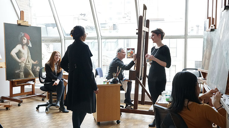 Conservators talking and working in the paintings studio